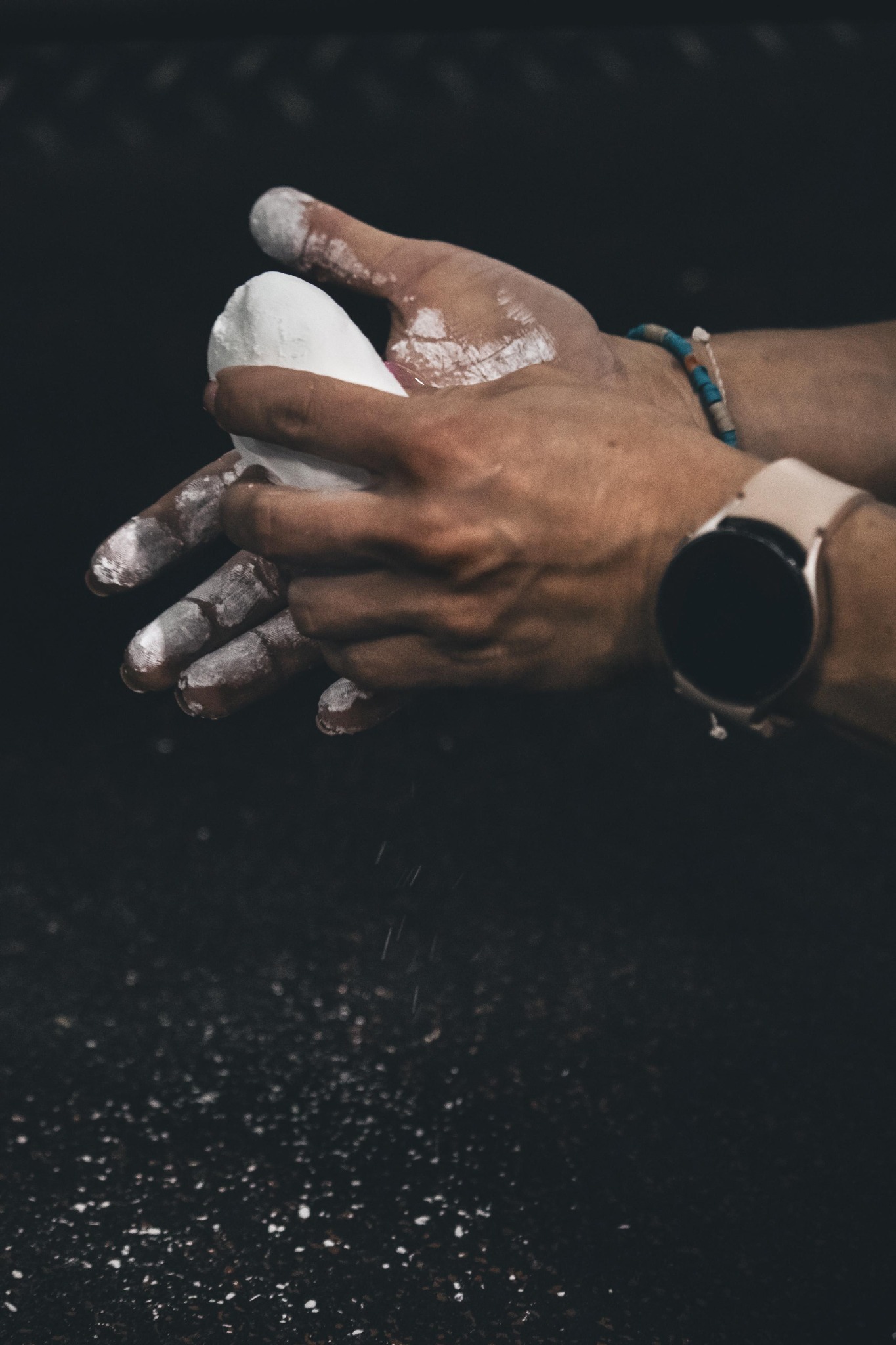Hands applying chalk before training